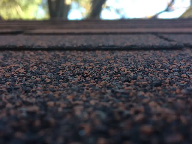 Close-up of shingle granules on a roof surface