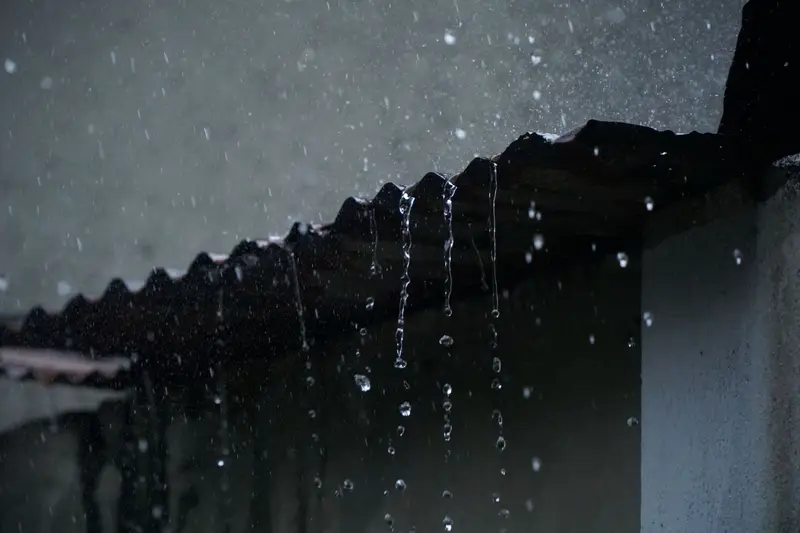 Rain dripping off the edge of a roof
