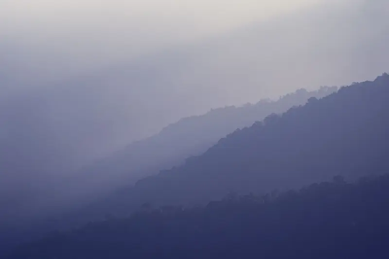 Layered blue mountain ridges in haze